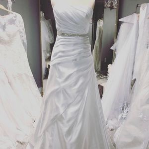 Simple white satin wedding gown.